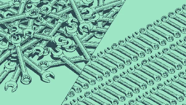 Wrenches tangled in a heap beside wrenches lined up in neat rows
