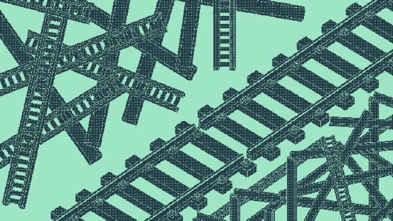 Railroad track segments in a chaotic crisscross beside straight parallel lines